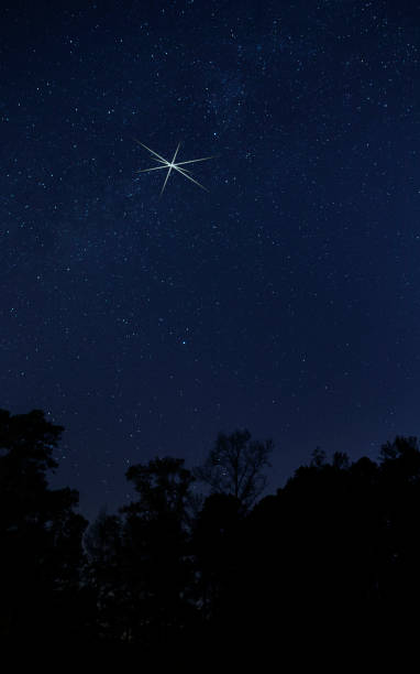 istock Christmas star shining bright on a dark night 1336715140