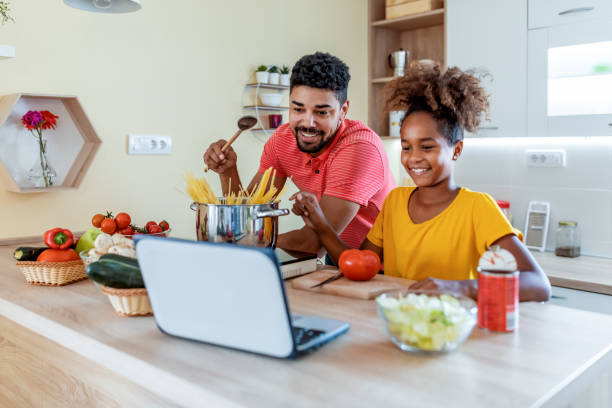 istock Father and daughter make spaghetti in the kitchen at home 1336715284