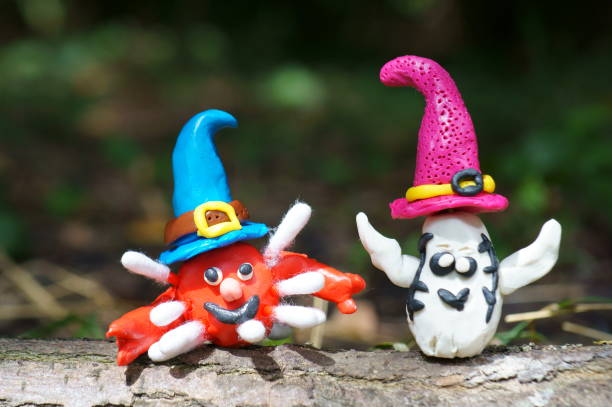 istock Figures of a ghost and a virus made of plasticine in a festive hat. 1336715565