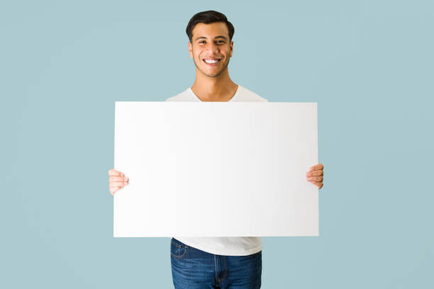 istock Cheerful latin man carrying a blank ad 1336717460