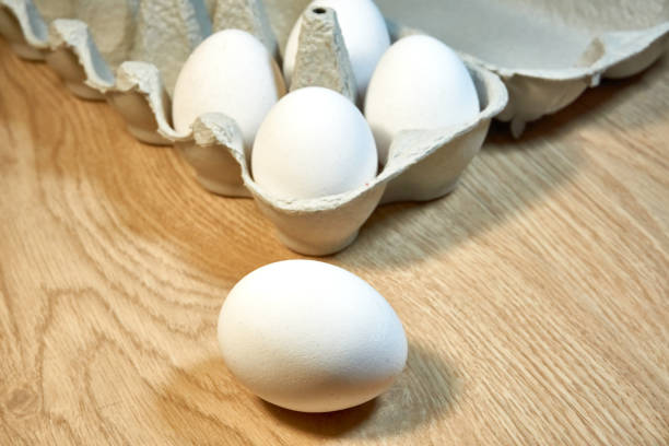 istock Raw chicken eggs in a cardboard box on the table. 1336718704
