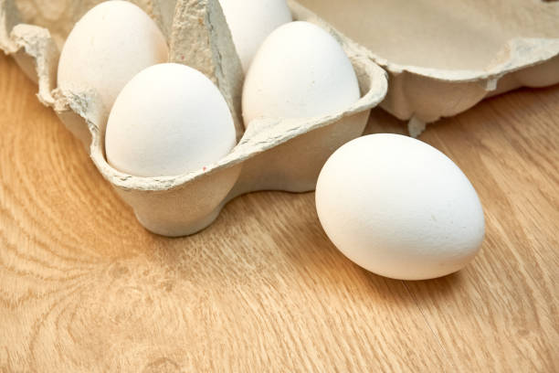 istock Raw chicken eggs in a cardboard box on the table. 1336718710