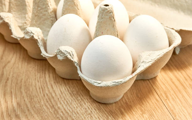 istock Raw chicken eggs in a cardboard box on the table. 1336718744