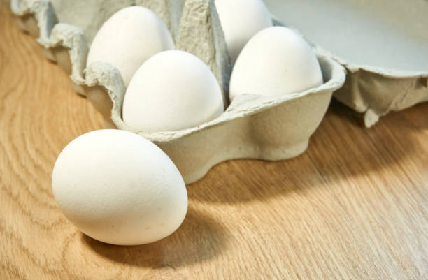 istock Raw chicken eggs in a cardboard box on the table. 1336719303