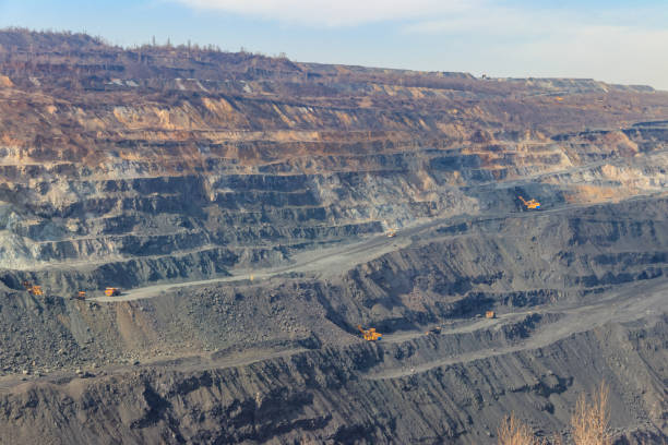 istock Huge iron ore quarry with working dump trucks and excavators 1336720684