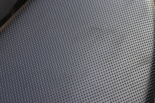 Close-up view of motorcycle leather texture on the backseat. Leather textured abstract background.