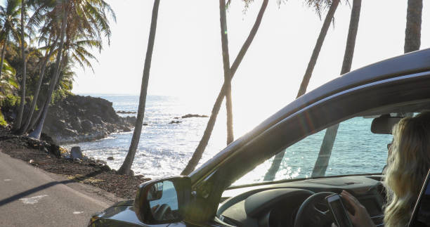 istock Woman enjoys driving along coastal road 1336724381