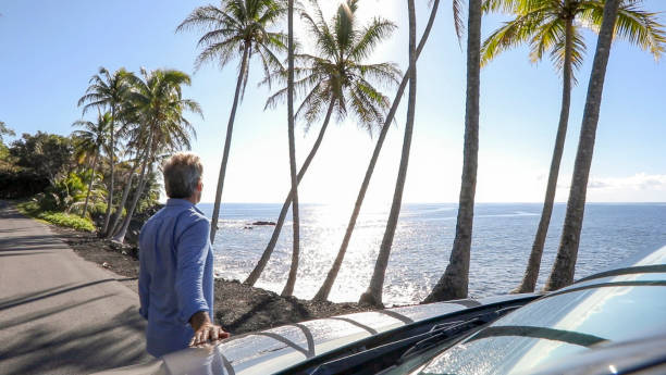 istock Man enjoys driving along coastal road 1336724518