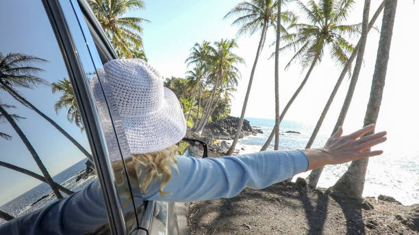 istock Woman enjoys driving along coastal road 1336724545
