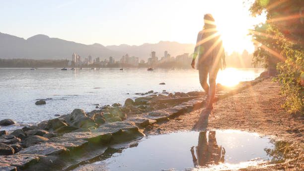 Woman enjoys walking along coastal pathway