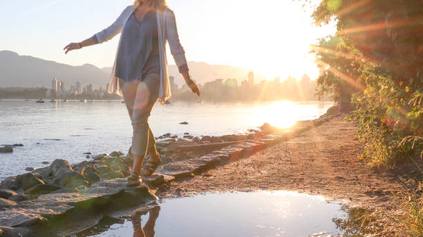istock Woman enjoys walking along coastal pathway 1336724571