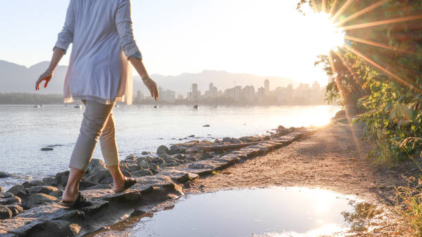 istock Woman enjoys walking along coastal pathway 1336724606