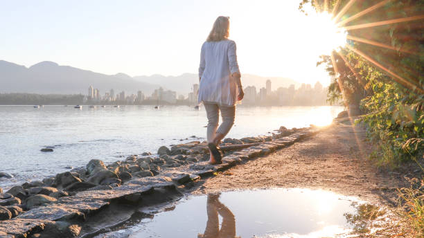 istock Woman enjoys walking along coastal pathway 1336724617