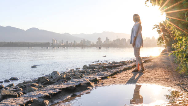 istock Woman enjoys walking along coastal pathway 1336724637
