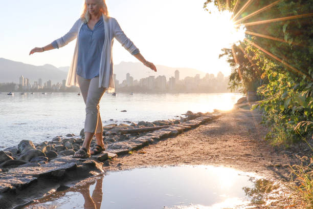 istock Woman enjoys walking along coastal pathway 1336724662