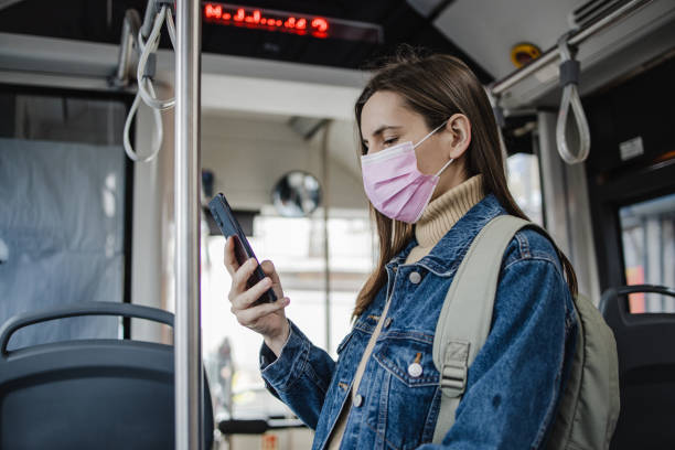 istock Using phone in public transport during pandemic 1336724852