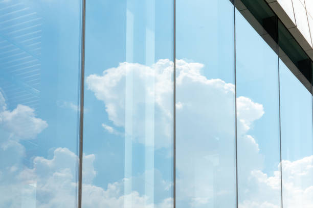 istock modern office building exterior with clouds reflects on window. 1336725699