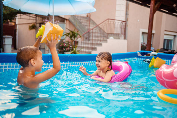 istock Children games in swimming pool 1336725709