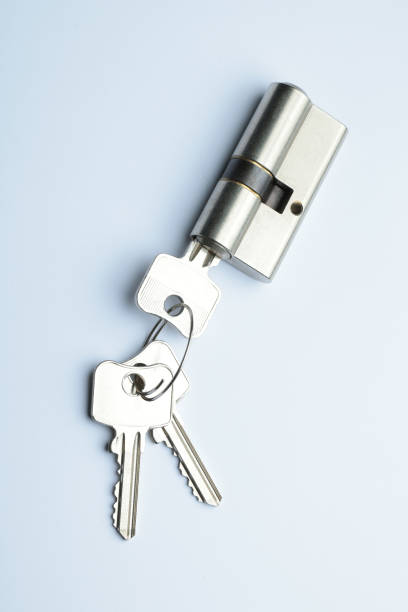 Door lock assembly and new keys on light blue background