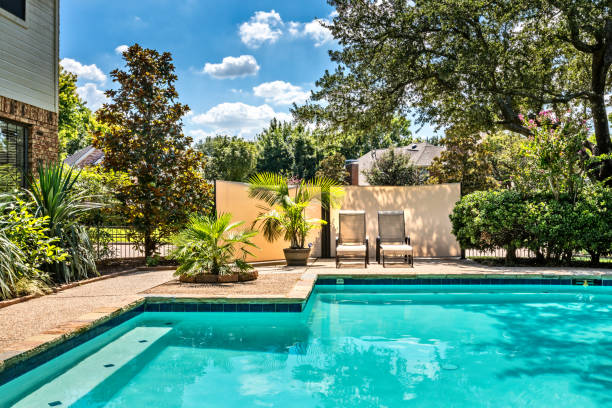 Backyard oasis with a swimming pool inside a private residential backyard Backyard oasis with a swimming pool inside a private residential backyard back yard stock pictures, royalty-free photos & images