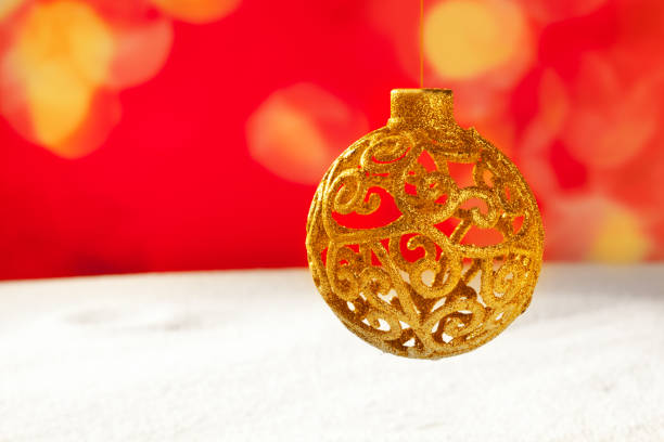 istock Arabesque christmas golden bauble on snow 1336730678