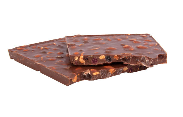 istock milk chocolate with nuts and berries brocken isolated on the white 1336731785