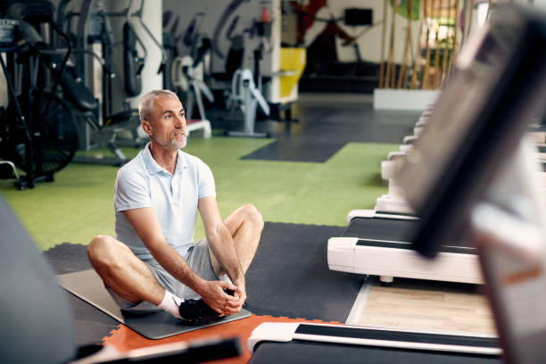 istock Mature sportsman warming up while exercising in a gym. 1336733687