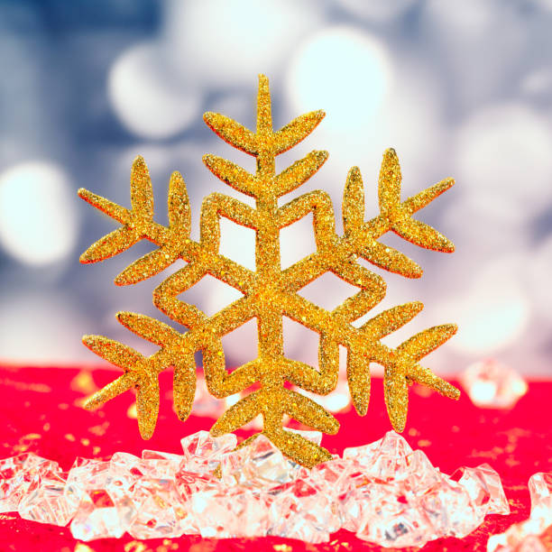 istock Christmas golden snowflake on ice cubes 1336738290