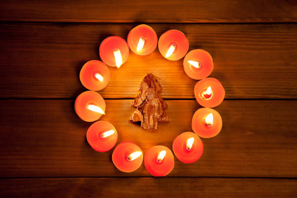 istock christmas candles circle over wood and symbol 1336740578