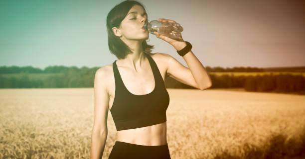 istock Young girl drinks refreshing water from a bottle. 1336742592