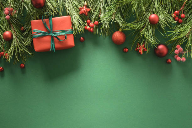 istock Christmas frame with red gift box, pine branches, and red balls. Xmas greeting card. Happy New Year. 1336747778