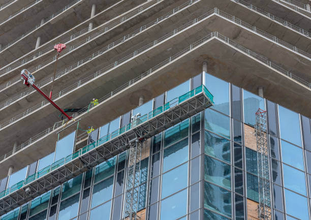 Workers inserting windows on a high-rise building, Frankfurt am Main, Germany stock photo