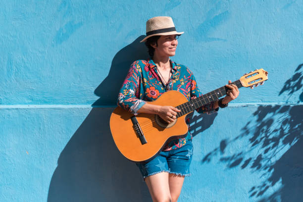 istock Woman playing guitar while walking in the park 1336748466