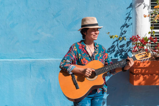 istock Female Musician With A Guitar On A street 1336748512
