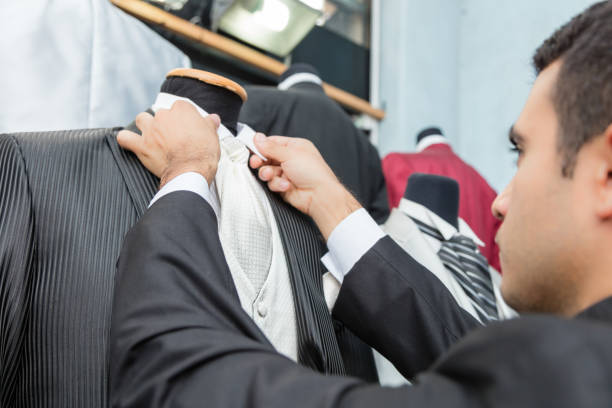 istock Tailor adjusting necktie of mannequin at shop 1336753667
