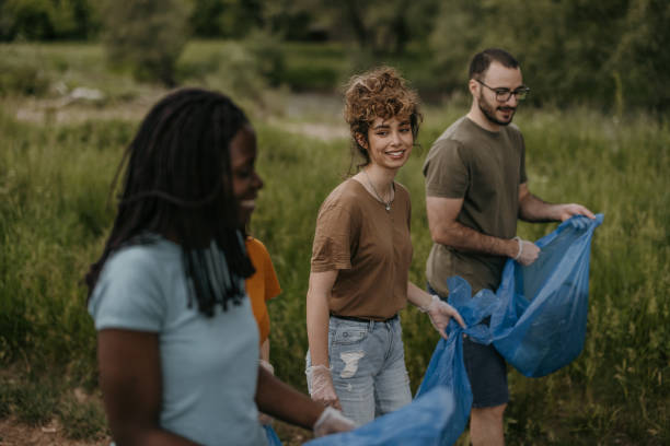 istock Group of young volunteers picking and collecting garbage from forest 1336759844