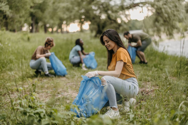 istock Young volunteers collecting garbage from forest in garbage bags 1336760426