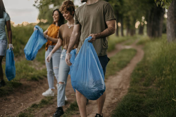 istock Group of young volunteers picking and collecting garbage from forest 1336760701