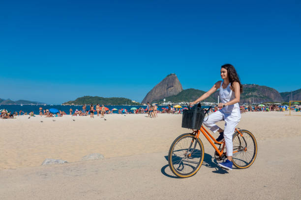 une jeune femme fait du vélo à praia do flamengo - parc flamengo photos et images de collection