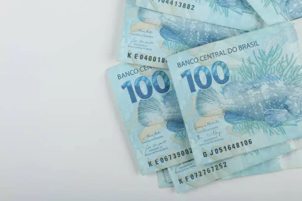 Photo of Brazilian money. 100 reais banknotes. Copy space