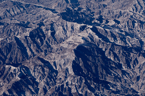Aerial view of extreme rugged mountainous terrain over northern China.