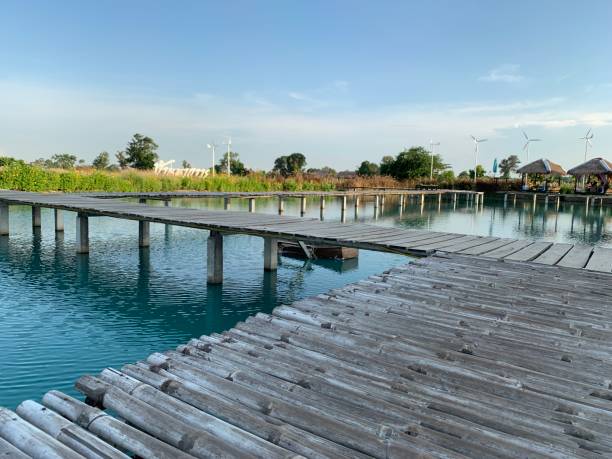 istock wooden bridge over a pond in the field 1336790461