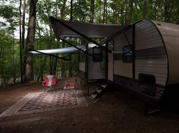 istock Camper trailer as night approaches in a forest 1336791120