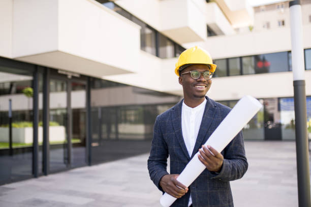 Young African American engineer standing at financial district.