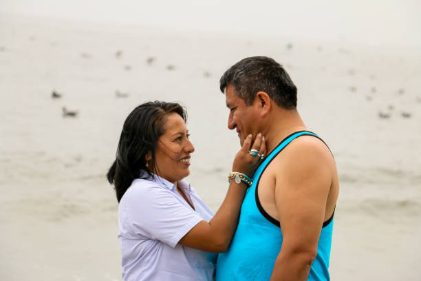 istock Tender older ethnic couple in love, standing next to a beach. 1336801732