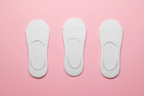 istock Three pairs of packed women's white short socks on a pink background. 1336803495