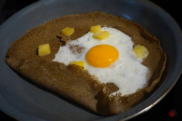istock Breton pancake with egg and cheese being cooked in a pan 1336806394