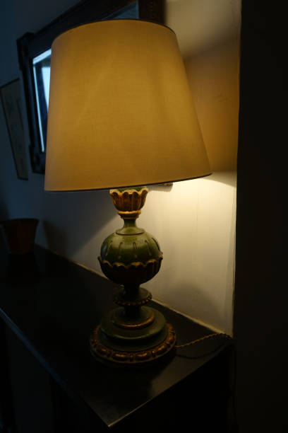 istock Lamp with retro-style lampshade  Lamp on and placed on a low cabinet 1336806402
