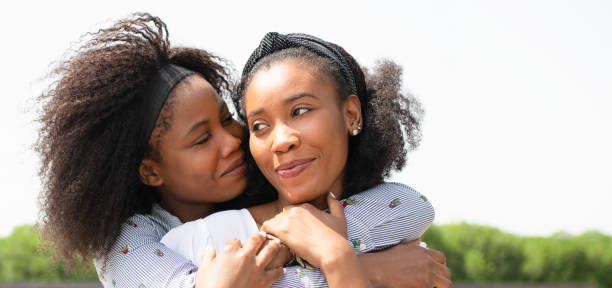 istock Lesbian couple hugging each other while standing outdoors. 1336807104