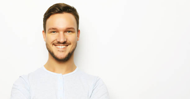 istock happy smiling man looking at camera on white background 1336808230